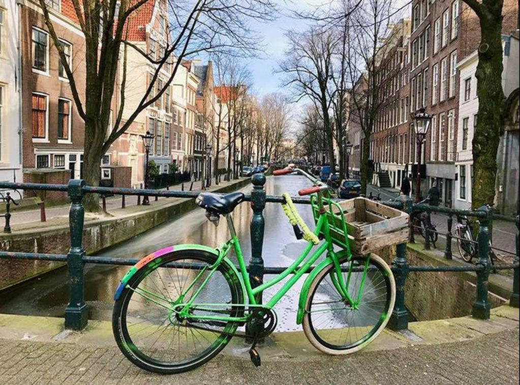 Bike on bridge over canal in Amsterdam